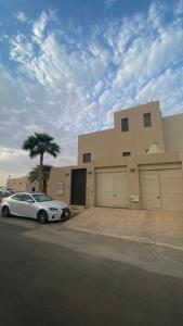 a white car parked in front of a building at Cozy privet unit شقة وحيدة وهادئة in Riyadh