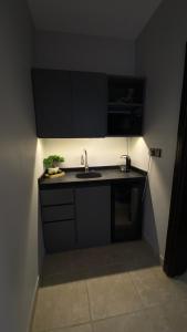 a small kitchen with a sink and a microwave at Cozy privet unit شقة وحيدة وهادئة in Riyadh