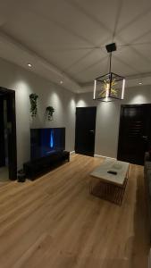 a living room with a couch and a flat screen tv at Cozy privet unit شقة وحيدة وهادئة in Riyadh
