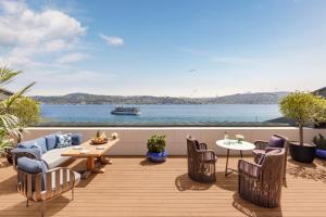 a deck with chairs and tables and a view of the water at Mandarin Oriental Bosphorus, Istanbul in Istanbul