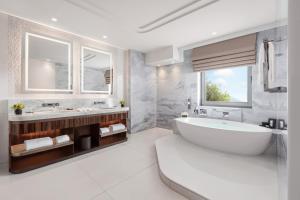 a white bathroom with a tub and a sink at Mandarin Oriental Bosphorus, Istanbul in Istanbul +88 photos
