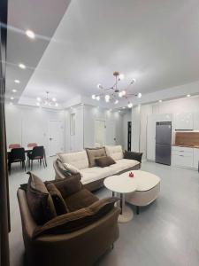 a living room with a couch and a table at Och Service Apartment in Ulaanbaatar