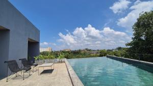 a swimming pool on the roof of a building at Stillwater Edge 2 - Level Two in Sri Jayewardenepura Kotte