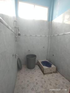 a bathroom with a shower and a toilet in it at Penginapan Verlo in Payakumbuh