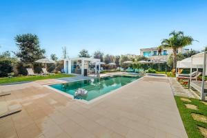 a swimming pool in a yard with a house at 7 Bedroom Luxury Villa - Pool, Garden & Parking - Happy Rentals in Scorrano
