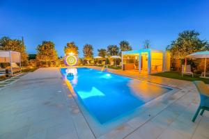 a large swimming pool in a yard at 7 Bedroom Luxury Villa - Pool, Garden & Parking - Happy Rentals in Scorrano