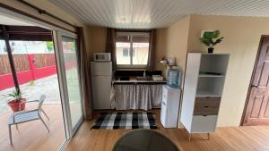 a small kitchen with a refrigerator and a table at Hiti Village G2 in Tikehau Airport