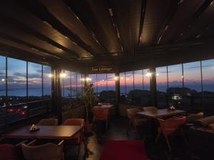 a restaurant with tables and chairs and a view of the city at GRANDROYAL HOTEL in Gümüşyaka