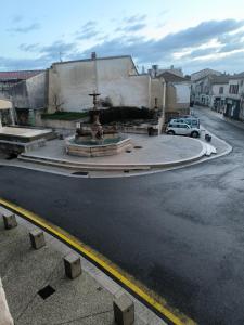 a fountain in the middle of a city street at Appartement Bellegarde in Bellegarde