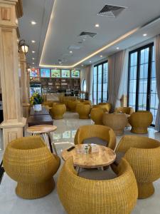 a lobby with wicker chairs and tables in a store at Green Hotel in Khánh Dương