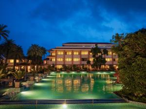 a pool in front of a building at night at Taj Alibaug Resort & Spa, Maharashtra in Alibaug