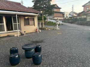 a group of blue stools sitting in the middle of a street at Kominka Himejuku in Tajimi