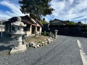 a stone fire hydrant on the side of a road at Kominka Himejuku in Tajimi