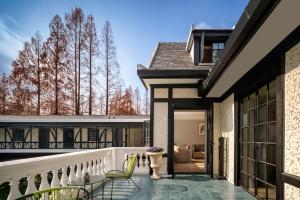 a balcony with a view of a house at ANHE GARDEN HOTEL in Shanghai