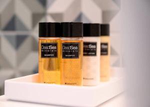 four bottles of essential oils on a shelf at אחוזת נופש ביער -ווילה עם בריכת ספא וזרמי עיסוי in Ma'alot Tarshiha