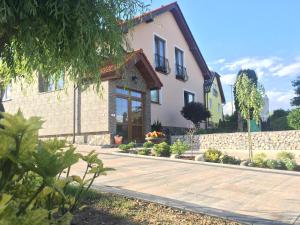 a house with a stone walkway in front of it at Penzion Werbew in Vrbov