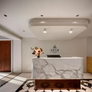 a lobby with a marble counter with a vase of flowers at ANHE GARDEN HOTEL in Shanghai