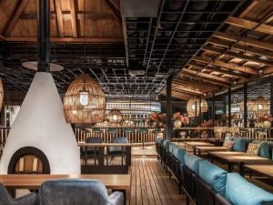 a restaurant with tables and chairs and a bar at Deer Chaser Hotel - Sun Moon Lake in Yuchi