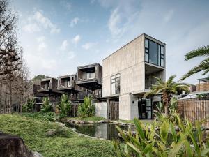 a house with balconies on the side of it at Deer Chaser Hotel - Sun Moon Lake in Yuchi