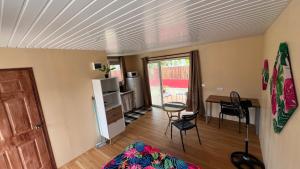 a room with a kitchen and a table and chairs at Hiti Village G3 in Tikehau