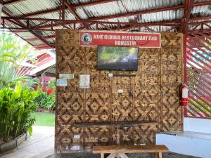 a wall with a sign on it with a bench at Nine Clouds Homestyle Accommodation in General Luna