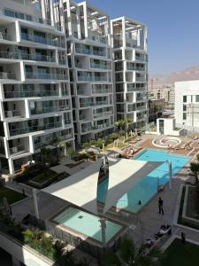 an aerial view of a large apartment complex with a swimming pool at Amor Club Luxury Suite in Eilat