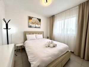 a bedroom with a bed with a teddy bear on it at STAY Sun Line Apartment in Nicosia