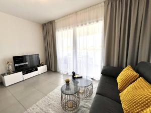 a living room with a couch and a tv at STAY Sun Line Apartment in Nicosia