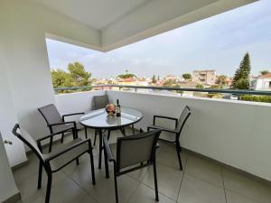 a table and chairs on a balcony with a view at STAY Sun Line Apartment in Nicosia