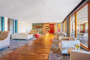 a lobby of a hotel with couches and tables at SunSquare Cape Town Gardens in Cape Town