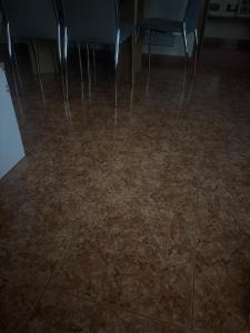 a room with a tile floor with chairs and tables at Llano Urban Park in Murcia