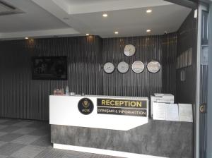 a reception counter with clocks on the wall at Grand royal hotel in Gümüşyaka