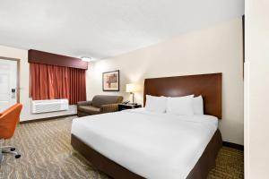 a hotel room with a large bed and a chair at Quality Inn Mount Vernon in Mount Vernon +45 photos