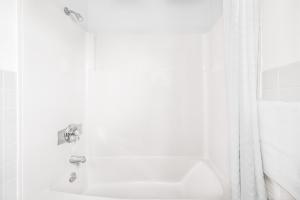 a white bathroom with a sink and a shower at Knights Inn Pine Grove in Pine Grove +20 photos