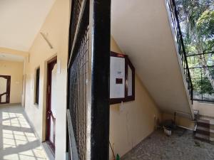 a hallway of a building with a staircase and a window at Le DPS Viste in Rāyampālaiyam +4 photos