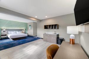 a hotel room with a bed and a sink at Comfort Inn & Suites Weston - Wausau in Weston +41 photos