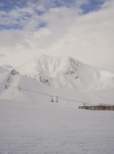 a ski lift in front of a snow covered mountain at Noém Hotel in Erzurum