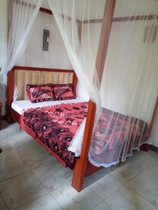 a bedroom with a bed with a canopy at The Window in Matara
