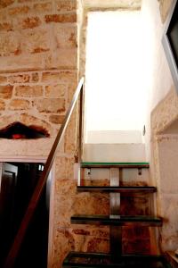 a staircase in a brick building with a window at Dream Home in Ostuni