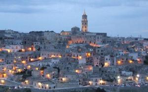 a view of a city at night at Le Casette in Matera