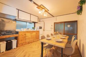 a kitchen with a table and chairs in a room at Yokosuka Guest House in Yokosuka