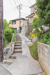 a set of stairs leading up to a house at Yokosuka Guest House in Yokosuka
