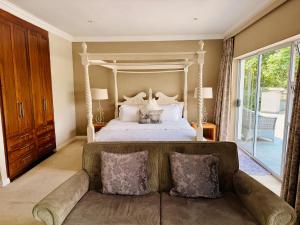 a bedroom with a large bed and a couch at The Wesley Boutique Hotel & Spa in Johannesburg +141 photos