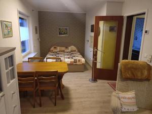 a room with a table and a bed in a room at FEWO Stephan Grünewald in Gunzenhausen