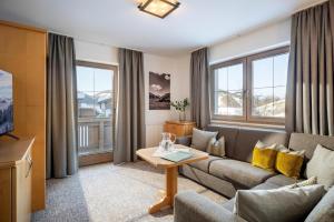 a living room with a couch and a table at Appartements Metzgerhof in Niederau