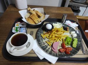 a tray with a plate of french fries and a cup of coffee at GRANDROYAL HOTEL in Gümüşyaka