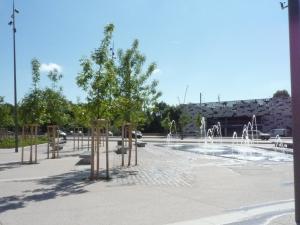 une fontaine dans un parc avec un bâtiment en arrière-plan dans l'établissement Appartement des Vignes, à Metz