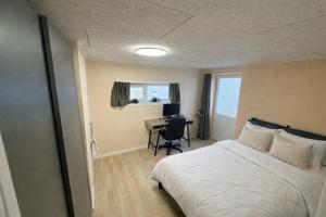 a hotel room with a bed and a desk at Hel hus i rolig by in Birkelse