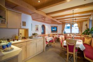 a kitchen and dining room with tables and chairs at Appartements Metzgerhof in Niederau