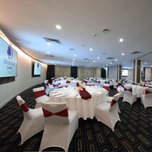 a banquet room with white tables and white chairs at DoubleTree by Hilton Cairns in Cairns +54 photos